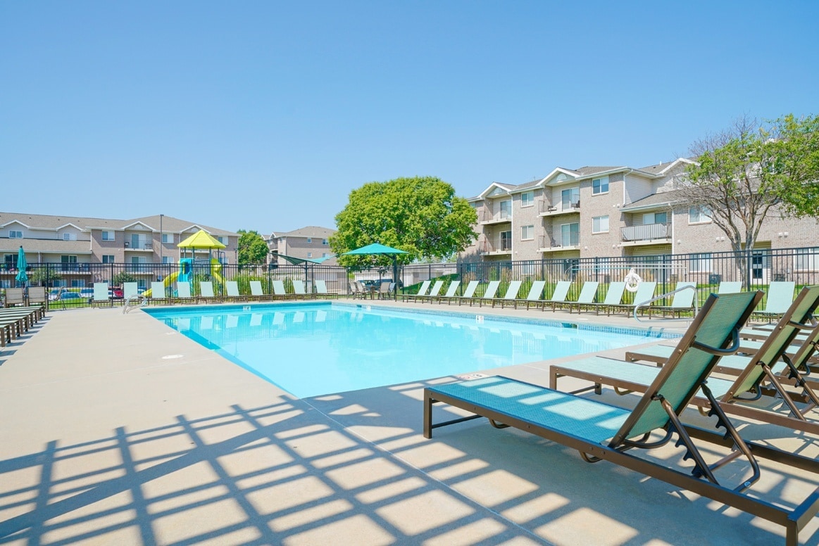 Take a dip in our pool or catch some rays on our pool deck. - Highland View Apartments