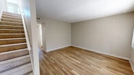 Located at 2925 Monument Blvd in Concord, California, this two-story, 3-bedroom, 2-bathroom home offers a functional and well-organized layout spread across two levels. The main floor features a living room with wood-look flooring, natural light streaming through large windows with vertical blinds, and a front entry door. The kitchen is designed with a pass-through counter, white cabinetry, a range, and a refrigerator, offering an open connection to the living area. A staircase leads to the upper floor, where all three bedrooms are located. The spacious primary bedroom provides ample room and includes a closet, while the additional bedrooms are similarly appointed with soft carpeting and windows that invite natural light. Neutral, warm-toned walls and textured ceilings are consistent throughout the home, creating a clean and cohesive aesthetic. Both bathrooms feature a tub-shower combo with sliding glass doors, wood-look flooring, white vanity cabinetry with stone-look countertops, and well-lit mirrors. The overall ambiance of the home is bright, neutral, and move-in ready, making it a practical and comfortable residence in the heart of Concord.