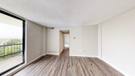 Located at 303 Effingham St in Portsmouth, Virginia, this single-floor unit offers a well-organized layout with a clean, neutral design that creates a bright and welcoming atmosphere throughout. The main living area is generously sized, featuring durable wood-look plank flooring, soft neutral wall tones, and a textured ceiling. Large floor-to-ceiling sliding glass doors open to a private balcony, flooding the space with natural light and offering pleasant elevated views of the surrounding greenery. The kitchen is thoughtfully appointed with white shaker-style cabinetry, light quartz countertops, a stainless steel sink, and a gas range, all complemented by wood-look flooring that ties the space together. The bedroom is carpeted for added comfort and includes a window with outdoor views, providing a tranquil retreat. The bathroom is finished in a crisp, clean white palette, featuring a tiled tub-and-shower combination, a white vanity with under-cabinet storage, a mirrored medicine cabinet, and updated lighting fixtures. Consistent use of neutral tones, modern hardware, and updated finishes across all rooms creates a cohesive and move-in-ready environment in this Portsmouth residence.