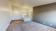 This 830 square foot apartment in Columbus, Ohio offers a practical and efficient living space. The single-story layout comprises two bedrooms, one bathroom, and an open-concept living and kitchen area. The primary bedroom, measuring 180 square feet, provides a spacious retreat.

The kitchen features white cabinetry, a breakfast bar, and modern appliances, including a refrigerator and electric range. The adjoining living area seamlessly blends with the kitchen, creating an open and inviting atmosphere. Warm wood flooring in the kitchen and living spaces contrasts nicely with the neutral carpeting found in the bedrooms.

Both bedrooms are equipped with ceiling fans and windows, allowing for natural light and air circulation. The bathroom, while compact, includes a tub-shower combination and a single vanity. Storage is abundant throughout the apartment, with a walk-in closet featuring wire shelving systems.

The property's practical design is evident in its use of space-saving features and neutral color palette. Window air conditioning units and baseboard heating provide climate control. This apartment offers a comfortable and low-maintenance living option in a convenient Columbus location.