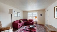 Located in Memphis, TN, this single-floor, 2-bedroom, 1-bathroom residence offers a functional and comfortable layout designed for everyday living. The living room serves as the heart of the home, featuring plush carpeting, a textured ceiling, and a large picture window that fills the space with natural light. The open feel is enhanced by neutral walls that provide a versatile backdrop throughout.

The kitchen is equipped with dark cabinetry offering ample storage, a double-basin sink, a black electric range with overhead ventilation, and a full-size refrigerator. Rich hardwood-style flooring anchors the kitchen and flows into the adjacent dining area, which provides a dedicated space for meals. A separate second room is ideal for use as a home office or additional sitting area, complete with natural light from a window with blinds.

Both bedrooms feature soft carpeting and neutral tones, offering a calm and restful atmosphere. The full bathroom includes a tub/shower combination, hardwood-style flooring, and a clean, efficient layout. Throughout the residence, the floor plan connects each area with a logical flow, making efficient use of the available space. This home delivers a straightforward, move-in-ready living experience in a convenient Memphis location.