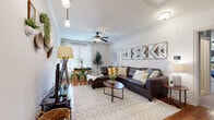 Located at 707 Sanctuary Pl in Charlotte, NC, this well-designed single-story home offers three bedrooms and five bathrooms across a comfortable and efficiently organized floor plan. The open-concept living and dining area serves as the heart of the home, featuring rich hardwood floors, crown molding, and a ceiling fan that enhances airflow and comfort. Natural light pours in through large windows fitted with blinds, illuminating the space with a warm, inviting ambiance. The kitchen is a functional highlight, boasting granite countertops, a peninsula with bar seating, gray shaker cabinetry, stainless steel appliances including a refrigerator, a wall-mounted range hood, and a built-in wine rack — ideal for both everyday cooking and entertaining. Adjacent to the kitchen, a dedicated built-in storage wall with shaker-style cabinetry and open shelving provides ample organization space. The bedrooms are carpeted and comfortably sized, with the primary bedroom offering a generous footprint, natural light, and individual climate control. The bathrooms feature tile flooring and pedestal sinks, maintaining a clean and classic aesthetic throughout. This home combines practical layout with thoughtful design details, making it a well-rounded residence in Charlotte.