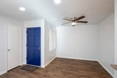 Located at 8081 9th St in Buena Park, California, this single-floor residence offers a well-organized layout with a clean, modern aesthetic throughout. The living area greets visitors with a bold blue entry door, warm wood-look flooring, recessed lighting, and a ceiling fan, while large windows fitted with vertical blinds allow generous natural light to fill the space. A sliding glass door opens directly to a private outdoor patio, extending the living area and providing views of the surrounding neighborhood.

The kitchen is designed with functionality in mind, featuring white shaker-style cabinetry, granite-look countertops, a pass-through bar connecting to the main living space, a range with overhead ventilation, and recessed lighting beneath a tray ceiling detail. This open connection between the kitchen and living area creates a cohesive, sociable flow.

The bedrooms are comfortably sized, each benefiting from natural light courtesy of well-placed windows. The wood-look flooring continues seamlessly throughout.

Two full bathrooms mirror each other in style, each offering white cabinetry with granite-look countertops, a framed mirror, and a tub-shower combo with white tile surround. Consistent finishes across both bathrooms contribute to a unified, polished interior design that carries throughout the entire residence.