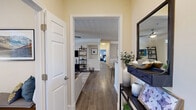 Located at 1201 Deer Trail in Milton, GA, this well-designed single-floor residence offers 2 bedrooms, 3 bathrooms, a dedicated office, and a thoughtfully organized layout that maximizes comfort and functionality. The living room is bright and welcoming, featuring a ceiling fan, large windows with ample natural light, and direct access to an outdoor area through a glass-panel door. The formal dining room is finished with crown molding, wainscoting, and hardwood-style flooring, creating an elegant setting for entertaining. The kitchen is outfitted with white cabinetry extending to the ceiling, generous counter space, and full appliances. The spacious primary bedroom includes a ceiling fan, plush carpeting, a large window with outdoor views, and convenient access to a walk-in closet and en suite bath. The additional bedroom is equally well-appointed with similar finishes and a ceiling fan. Each bathroom features tub-shower combinations with tile surrounds and hardwood-style flooring. The dedicated office provides a quiet, naturally lit workspace. Throughout the residence, a neutral, warm color palette and consistent finishes create a cohesive and inviting ambiance suited to a variety of lifestyles.