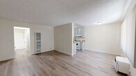 Located on Foothill Blvd in Tujunga, CA, this single-level 1-bedroom, 1-bathroom unit offers a clean, functional layout across a compact but efficient floor plan. Light wood-style flooring flows throughout the main living areas, complemented by neutral cream-toned walls and textured ceilings that lend a bright, airy feel.

The open living and dining area provides a comfortable gathering space, with a wall-mounted heating unit and a window dressed in vertical blinds that allows natural light to filter in. A dedicated entry area with a front door and welcome mat adds a practical touch.

The galley-style kitchen is well-equipped, featuring gray cabinetry on both sides, warm wood-toned countertops, a stainless steel sink, and a white gas range with overhead ventilation. Ample upper and lower cabinet storage maximizes the efficient use of space.

The bedroom is carpeted for warmth and comfort, offering a spacious feel with a large window fitted with vertical blinds and a sliding-door closet with a built-in hanging rod. A hallway connects the bedroom to the full bathroom, which includes a single-sink vanity with under-sink storage, a toilet, and a tub/shower combination. The unit also features a dedicated hallway closet for additional storage.