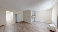 Located on Foothill Blvd in Tujunga, CA, this single-level 1-bedroom, 1-bathroom unit offers a clean, functional layout across a compact but efficient floor plan. Light wood-style flooring flows throughout the main living areas, complemented by neutral cream-toned walls and textured ceilings that lend a bright, airy feel.

The open living and dining area provides a comfortable gathering space, with a wall-mounted heating unit and a window dressed in vertical blinds that allows natural light to filter in. A dedicated entry area with a front door and welcome mat adds a practical touch.

The galley-style kitchen is well-equipped, featuring gray cabinetry on both sides, warm wood-toned countertops, a stainless steel sink, and a white gas range with overhead ventilation. Ample upper and lower cabinet storage maximizes the efficient use of space.

The bedroom is carpeted for warmth and comfort, offering a spacious feel with a large window fitted with vertical blinds and a sliding-door closet with a built-in hanging rod. A hallway connects the bedroom to the full bathroom, which includes a single-sink vanity with under-sink storage, a toilet, and a tub/shower combination. The unit also features a dedicated hallway closet for additional storage.