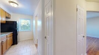This one-bedroom, one-bathroom unit at 1 Chester Cir in New Brunswick, NJ offers a well-organized single-floor layout with a practical mix of spaces. The combined living and dining area is spacious and bright, showcasing warm hardwood floors that extend throughout the main living spaces. Multiple windows allow natural light to fill the rooms, providing pleasant views of the surrounding neighborhood. A ceiling fan in the living area adds comfort and functionality.

The kitchen is equipped with warm-toned wood cabinetry, tile flooring, a tile backsplash, granite-style countertops, and black appliances including a gas range, microwave, and refrigerator. The layout is efficient and provides ample counter and storage space.

The bedroom features the same rich hardwood flooring, a ceiling fan with light fixture, and windows that invite in natural light. Multiple closets — five throughout the unit — offer exceptional storage capacity rarely found in similarly sized homes.

The bathroom is neatly finished with large-format tile surround, a decorative mosaic accent border, a soaking tub, and a window for natural ventilation. The hallway, finished in light tile flooring, connects the spaces cleanly. Overall, the unit presents a clean, neutral palette ideal for comfortable everyday living.
