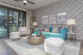 Located at 3425 Malone Dr in Chamblee, Georgia, this thoughtfully designed single-floor residence blends contemporary style with refined comfort throughout every room. The open-concept kitchen is a standout, featuring granite countertops, a large center island with a deep sink and gooseneck faucet, taupe shaker-style cabinetry extending to the ceiling, a classic white subway tile backsplash, and a full suite of stainless steel appliances. Globe pendant lights suspended above the island add a modern, decorative touch, while rich hardwood-style flooring flows seamlessly through the main living areas. The living room makes a bold design statement with a textured geometric accent wall, a vibrant teal sofa, and a curated gallery of framed artwork, creating a warm and inviting atmosphere. The bedroom offers a tranquil retreat, highlighted by a textured accent wall, plush carpeting, large windows that invite natural light and urban views, and a ceiling fan for added comfort. The bathroom is elegantly appointed with an extended double vanity topped with granite, white shaker cabinetry, large-format tile flooring, a geometric patterned runner, and a glass-enclosed shower. Together, these spaces deliver a polished, cohesive living experience with upscale finishes throughout.