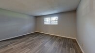 Located at 12445 W 97th Ter in Lenexa, Kansas, this single-floor, 2-bedroom, 2-bathroom residence offers a practical and comfortable layout. The living room features wood-look plank flooring and a textured ceiling, with a window that brings in natural light, creating an inviting atmosphere. The galley-style kitchen is well-equipped with white cabinetry, white countertops, a double stainless steel sink, and stainless steel appliances including a refrigerator and electric range with overhead ventilation. Wood-look flooring continues throughout the kitchen and main living areas. Both bedrooms are carpeted and feature ceiling fans with light fixtures and soft neutral wall tones. The spacious primary bedroom includes a closet and connects conveniently to the hallway. The two bathrooms offer distinct configurations: one features a full tub-shower combo with white subway tile surround, while the other includes a glass-enclosed walk-in shower. A hallway connects the main living spaces to the bedrooms and bathrooms, providing a well-organized flow throughout the home. The overall design is clean and functional, making this Lenexa residence a well-structured and move-in ready space.