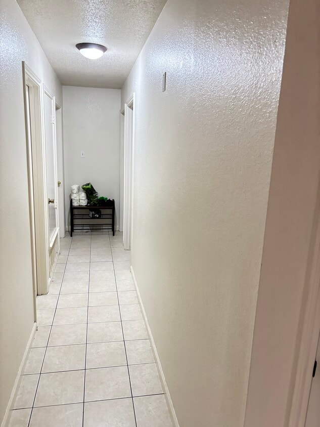 Hallway to bathroom and the 3 bedrooms. - 1605 Texas Oak Way
