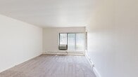 Located at 2607 Senate Dr in Lansing, MI, this 2-bedroom, 1-bathroom unit offers a practical and comfortable single-floor layout. The spacious living room features neutral-toned carpet, white walls, and a large window with vertical blinds that invites natural light and views of the surrounding greenery. Baseboard heating runs throughout the carpeted areas, ensuring warmth year-round.

The kitchen is well-appointed with warm cherry wood cabinetry, granite-style countertops, a white electric range, a dishwasher, and a stainless steel sink. Light tile flooring and multiple windows, including a view to the front entry door, give the kitchen a bright and open feel. A ceiling fan in the adjoining dining area adds to the functionality of the space.

Both bedrooms are carpeted and feature windows with vertical blinds, offering natural light and outdoor views. The primary bedroom includes a built-in closet with sliding doors, providing convenient storage. Additional hallway spaces connect the rooms efficiently throughout the unit.

The bathroom is outfitted with a tiled tub and shower combination, chrome fixtures, and grab bars for added safety. A dedicated closet provides extra storage. The overall design is clean, bright, and move-in ready.
