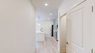 Located at 210 Brunswick Pl in Myrtle Beach, SC, this well-appointed single-floor residence offers a thoughtfully designed layout with modern finishes throughout. The open-concept kitchen and living area serves as the heart of the home, showcasing sage-toned shaker cabinets, quartz countertops, a subway tile backsplash, stainless steel appliances, and a central island with pendant lighting — all set atop light-toned hardwood flooring. The living area features vaulted ceilings and access to a private balcony through a glass door flanked by windows, filling the space with abundant natural light and outdoor views. The bedroom is generously sized, carpeted for comfort, and benefits from a ceiling fan and multiple windows with exterior views. A second carpeted room with a ceiling fan and natural light offers flexible use as a guest space or home office. The full bathroom is finished with a sage shaker vanity, quartz countertop, brushed gold fixtures, and a tub/shower combo. A dedicated closet provides practical storage. The consistent use of light tones, natural light, and quality materials creates a clean, cohesive, and welcoming ambiance throughout the entire residence.