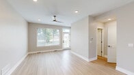 Located at 28509 Franklin Rd in Southfield, Michigan, this multi-level townhouse spans three floors and offers a well-organized layout with 2 bedrooms and 3 bathrooms. The main living level features an open kitchen and living room area finished with light hardwood-style flooring, a ceiling fan, and large windows that invite abundant natural light and outdoor views. The kitchen is well-appointed with granite countertops, white cabinetry, dark wood accent storage, stainless steel appliances including a French door refrigerator and gas range, and a subway tile backsplash. A convenient half bathroom on this level features a granite-topped vanity and wood-framed mirror. The upper floor houses the bedrooms, each carpeted in a neutral tone. The generously sized primary bedroom includes access to a dedicated walk-in closet with wire shelving systems. The full bathrooms are finished with granite vanity tops and tub-shower combinations. The entry level features light hardwood-style flooring and a front door with transom window, adding a welcoming touch. The unfinished basement provides considerable open space with framed walls and utility systems already in place, offering strong potential for future customization. Throughout, the home maintains a neutral, modern color palette with clean white trim and understated finishes.