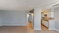Located at 3400 Garden Oaks Dr in New Orleans, LA, this single-floor, 2-bedroom, 1-bathroom residence offers a straightforward and functional layout. Throughout the home, light-toned wood-look flooring provides a clean, cohesive look, complemented by soft gray walls and white baseboards.

The living room is a welcoming open space featuring a ceiling fan, a textured ceiling, and multiple windows fitted with blinds that allow natural light to fill the room. A central hallway connects the living area to the rest of the home, lined with wall sconces for added warmth.

The kitchen is efficiently designed with white cabinetry, granite-patterned countertops, a double stainless steel sink, a dishwasher, and a refrigerator. Upper and lower cabinets provide ample storage for daily needs.

Both bedrooms are quiet and well-proportioned, each with textured ceilings, gray walls, wood-look flooring, and windows with blinds that bring in natural light. Two closets offer convenient storage solutions. The bathroom is clean and functional, featuring a tiled tub-shower combination with beige tile surrounds, a toilet, and a vanity with wood-look flooring. The unit also includes a hallway that connects the main living spaces efficiently.