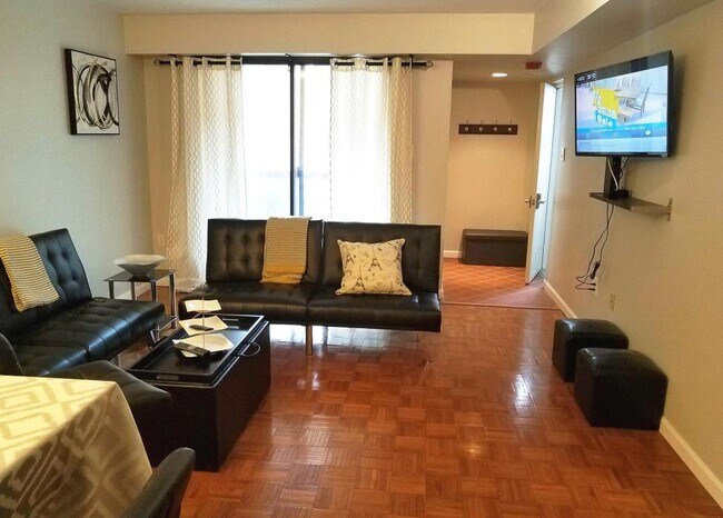 View of the living room, facing towards the front balcony. - 516 S 12th St