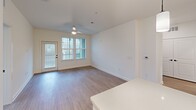 Located in North Augusta, SC, this well-appointed 2-bedroom, 3-bathroom residence offers a thoughtfully designed single-floor layout filled with modern finishes. Light-toned wood-look flooring runs throughout, complementing the clean, neutral color palette that defines each room.

The kitchen is a standout feature, showcasing white shaker-style cabinetry with matte black hardware, a white subway tile backsplash, quartz countertops, and a generous island with pendant lighting overhead. Stainless steel appliances, including a French door refrigerator, electric range, microwave, and dishwasher, complete this highly functional space.

The living area is bright and open, benefiting from natural light through multiple windows and a ceiling fan. A private exterior door provides convenient access. Both bedrooms are well-proportioned, each featuring ceiling fans, wood-look flooring, and windows dressed with horizontal blinds that invite natural light while maintaining privacy.

The bathrooms are finished to a modern standard, with white cabinetry, quartz vanity tops, matte black fixtures, and wood-look flooring. The primary bathroom includes a frameless glass walk-in shower with tile surround, while additional bathrooms offer versatile configurations. A dedicated closet rounds out the practical storage options in this move-in-ready North Augusta residence.