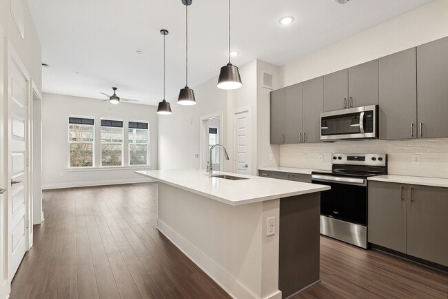 Island kitchen with ENERGY STAR® stainless appliances, quartz countertops and smart refrigerator - AMLI Brookhaven