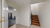 Located at 8745 Cedros Avenue in Panorama City, Los Angeles, this three-bedroom, three-bathroom residence is thoughtfully distributed across three floors, offering a well-organized layout with dedicated spaces for living, sleeping, and parking. The ground floor features a private attached garage with an automatic opener and direct interior access through a dedicated entrance area, providing both convenience and security. The main living level serves as the social hub of the home, showcasing a bright, open-plan kitchen and living room combination. The kitchen features warm wood cabinetry, granite countertops, and a sliding glass door that opens to an outdoor balcony, flooding the space with natural light. Recessed lighting and wide-plank hardwood-style flooring extend throughout the living area, creating an airy and cohesive atmosphere. The upper floor houses all three bedrooms and the remaining bathrooms. The bedrooms feature the same warm flooring, neutral walls, and windows with blinds for natural light and privacy. The primary bedroom includes a mirrored sliding-door closet. The bathrooms are finished with light tile flooring, white vanities with gold hardware, and enclosed tub-shower combinations. Two hallways connect the upper-level spaces efficiently, completing this functional and comfortable multi-floor home.