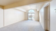 Located at 22388 Breakwater Dr in Elkhart, Indiana, this single-floor residence offers a well-organized layout with a variety of functional living spaces. The standout feature of the main living area is its soaring vaulted ceiling with exposed beams, anchored by a striking arched window above sliding glass doors that flood the room with natural light and provide outdoor views. Soft neutral-toned carpet runs throughout the living and bedroom areas, creating a cohesive and comfortable feel.

The kitchen is equipped with white cabinetry accented by wood-toned hardware, ample counter space, a gas range, and a dishwasher, all set over wood-look flooring. The layout is practical and efficient, offering good storage throughout.

The bedrooms are generously sized, each featuring plush carpeting and windows that bring in natural daylight. The primary bedroom shares the same dramatic arched window as the living area, reinforcing the architectural character of the space.

The bathrooms are clean and straightforward — one features a full tub/shower combo, while another includes a vanity with under-sink cabinetry, a mirrored medicine cabinet, and wood-look flooring. Overall, the space presents a bright, neutral palette with notable architectural details that give it a distinctive character.