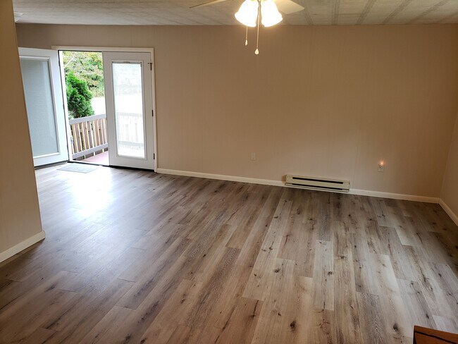 Living Room, Dining area and deck beyond - 503 Goose Pond Rd