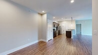 This thoughtfully designed 2-bedroom, 2-bathroom residence in Lynchburg, Virginia offers a comfortable and functional single-floor layout. The open-concept living, dining, and kitchen area serves as the heart of the home, featuring warm wood-look flooring, neutral toned walls, and a sleek fireplace. A ceiling fan complements the spacious living room, which opens directly to a private balcony through sliding glass doors, providing pleasant outdoor views of the surrounding community.

The kitchen is well-equipped with rich dark wood cabinetry, granite countertops, stainless steel appliances including a range, microwave, and refrigerator, and a convenient kitchen island. A pantry and dedicated laundry area add to the home's practicality, along with a utility room for additional storage.

Both bedrooms are carpeted and fitted with ceiling fans, offering a comfortable retreat. The generously sized primary bedroom includes access to a walk-in closet with extensive wire shelving. The two bathrooms are cleanly finished — one featuring a stand-alone shower with tile flooring, and the other a full soaking tub. With four closets throughout, this residence delivers ample storage to complement its well-organized, move-in-ready design.