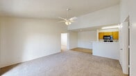 Located at 1700 Eagle Landing Blvd in Hanahan, SC, this single-floor, three-bedroom, two-bathroom home offers a well-designed layout with a bright and open feel throughout. The living area is a standout feature, boasting vaulted ceilings and a ceiling fan that enhance the sense of volume and airflow. Plush carpeting runs through the living space and bedrooms, while light wood-style flooring transitions into the kitchen and wet areas. A sliding glass door in the living room opens to a private balcony, allowing natural light to fill the space and offering outdoor views.

The kitchen is thoughtfully designed with warm wood cabinetry, black appliances including a refrigerator, range, and microwave, and a white peninsula countertop that connects the kitchen to the living area. Three well-proportioned bedrooms each feature carpet flooring and ceiling fixtures, with the primary bedroom offering its own closet. Two full bathrooms include tub/shower combinations, wood vanity cabinetry, and light countertops. Three total closets provide ample storage throughout. A dedicated laundry area and a hallway connecting the rooms complete this functional and comfortable floor plan.