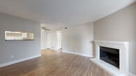Located at 2961 W Centennial Dr in Littleton, CO, this one-bedroom, one-bathroom single-level unit offers a thoughtfully arranged floor plan across a compact yet functional footprint. Wood-look flooring runs throughout the entire space, providing a cohesive and easy-to-maintain surface in every room.

The living room is the standout space, highlighted by a white brick fireplace with a raised hearth that serves as a natural focal point. A ceiling fan adds comfort, and vertical blinds on a large window allow for adjustable natural light. The textured ceiling carries throughout the common areas.

Adjacent to the living room, the kitchen is well-equipped with white shaker-style cabinetry, granite-look countertops, a stainless steel gas range, stainless refrigerator, and a built-in dishwasher. A skylight-style ceiling fixture brightens the workspace, and an open pass-through layout connects the kitchen to the main living area.

The bedroom is a comfortable, quiet space with a window fitted with white blinds, providing natural light. A dedicated closet offers storage, and the room maintains the same neutral color palette found throughout. The bathroom features wood-look flooring, a white vanity, and a shower/tub combination. Additional utility and laundry areas round out the practical amenities of this well-organized Littleton home.
