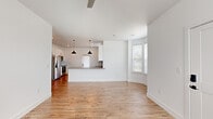 Located at 370 Homestead Ave in Greenwood, Indiana, this thoughtfully designed single-story home offers three bedrooms, two bathrooms, and a dedicated laundry room across a comfortable, well-utilized floor plan. The open-concept living and dining area flows seamlessly into the kitchen, where warm hardwood-style flooring, crisp white walls, and natural light from multiple windows create a bright, welcoming atmosphere. A curved bay window adds an architectural touch to the living space, enhancing the sense of openness.

The kitchen is equipped with stainless steel appliances—including a refrigerator, range, and over-the-range microwave—complemented by white shaker-style cabinetry, a subway tile backsplash, and neutral countertops. Sleek black hardware provides a modern contrast throughout.

The primary bedroom is generously sized, featuring a ceiling fan, natural light, and access to a spacious walk-in closet outfitted with multi-level shelving and hanging rods. The secondary bedrooms are finished with plush carpet and bright windows with outdoor views. Both bathrooms maintain a clean, modern aesthetic with white vanities, gray countertops, and black hardware accents. A dedicated laundry room accommodates a full-size washer and dryer, adding everyday convenience to this well-appointed home.