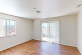 Located at 742 Olivera St in Guadalupe, California, this single-story home offers four bedrooms and two bathrooms within a compact, efficiently designed floor plan. Warm wood-look flooring flows consistently throughout the living areas and bedrooms, creating a cohesive and inviting aesthetic.

The kitchen is a functional highlight, featuring warm oak cabinetry, granite-patterned countertops, a gas range, a built-in dishwasher, and a window above the sink that brings in natural light. It is well-suited for everyday cooking and meal preparation.

Each of the four bedrooms is finished with the same wood-look flooring and neutral wall tones. The bedrooms are bright, with windows fitted with horizontal blinds providing both natural light and privacy. The primary bedroom includes sliding glass doors with vertical blinds that open to an outdoor area, adding an airy quality to the space.

The two bathrooms are clean and functional. One includes a tub-shower combination with white tile surround and chrome fixtures, while the other features a wooden vanity with a single sink, a large mirror, and light tile flooring.

A connecting hallway links the rooms efficiently, and the entrance provides a straightforward transition into the home. Overall, the space presents a practical and comfortable layout suited for everyday living.