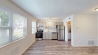 Located at 1013 Ingleside Ave in Catonsville, Maryland, this single-floor unit offers a clean, updated interior with a practical layout designed for comfortable everyday living. The open living area is finished with durable wood-look flooring and neutral walls, allowing natural light from multiple windows to brighten the space throughout the day.

The kitchen is a notable feature, equipped with stainless steel appliances including a range, dishwasher, and refrigerator. Gray shaker-style cabinetry provides ample storage, complemented by light countertops and a stainless steel sink. A track lighting fixture overhead ensures the kitchen is well-lit. Adjacent to the kitchen, a dedicated utility area accommodates in-unit washer and dryer hookups, adding everyday convenience.

The bedrooms are carpeted for comfort, each offering natural light via windows and access to closet space. The bathroom is finished in a crisp, all-white palette, featuring a tub-shower combination, toilet, and vanity with wood-look flooring tying the space together. Throughout the unit, the consistent use of neutral tones and updated finishes creates a bright, cohesive, and move-in-ready environment.
