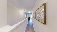 Located in Canton, Michigan, this two-story home offers four bedrooms and two bathrooms across a well-organized layout. The main living level is generously proportioned, anchored by a bright living room that opens through sliding glass doors to a private balcony with outdoor views — an ideal space for relaxing or entertaining. Crown molding and hardwood-style flooring run throughout, lending a polished, cohesive feel.

The kitchen is a standout feature, outfitted with white shaker cabinetry, granite countertops, a subway tile backsplash, stainless steel appliances, and warm pendant lighting. A dedicated laundry room with side-by-side washer and dryer adds everyday convenience.

The primary bedroom is a comfortable retreat, featuring a bold accent wall in a calming blue tone, plush carpeting, and direct access to closet space. Additional bedrooms are bright and well-sized, with large windows that invite natural light and garden views. The full bathroom includes a tub/shower combination in a clean, neutral finish.

Multiple hallways connect the rooms efficiently, and two closets offer organized storage throughout. The attached garage provides additional utility space. Crown molding details and consistent neutral tones give the home a refined, move-in-ready character throughout.