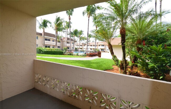 Lush landscaping with pool view from the living room and porch - 14500 SW 88th Ave