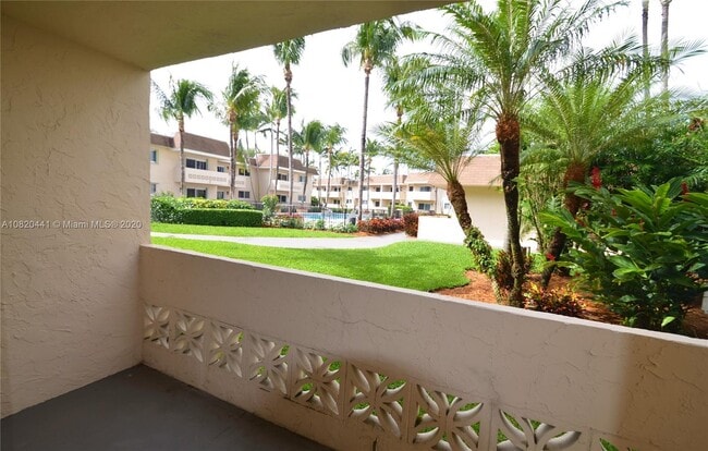 Lush landscaping with pool view from the living room and porch - 14500 SW 88th Ave Apartment