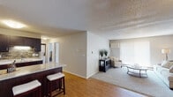 Located at 1515 Seventh St S in Waite Park, Minnesota, this single-floor residence offers a thoughtfully designed layout that balances comfort and functionality. The open-concept living and dining area features warm hardwood-style flooring, neutral toned walls, and a textured ceiling, creating a welcoming atmosphere. A large sliding glass door with vertical blinds fills the living room with natural light and provides easy outdoor access. The carpeted living room offers generous space for seating and relaxation.

The galley-style kitchen is a standout feature, boasting rich dark cabinetry, granite countertops, a tile backsplash, and stainless steel appliances including a refrigerator, electric range, microwave, and dishwasher. A breakfast bar with seating connects the kitchen to the main living area, making it ideal for casual dining or entertaining.

The residence includes multiple bedrooms, each carpeted and finished with neutral walls, natural light from windows, and closet storage. The bedrooms provide a quiet, comfortable retreat. The bathroom is well-appointed with a dark vanity, white countertop, large mirror, tile flooring, and a shower-tub combination. Overall, the space presents a clean, functional, and comfortable living environment suited for everyday living.