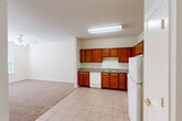 Located at 2056 Antoine Drive in Houston, Texas, this single-floor, 2-bedroom, 1-bathroom unit offers a practical and well-organized layout. The combined kitchen and dining area is a functional highlight, featuring warm medium-toned wood cabinetry arranged in an L-shape, granite-style countertops, a tile floor, and white appliances including a range, dishwasher, and refrigerator. A dedicated pantry provides additional storage. The kitchen flows openly toward the living room, which transitions to soft, neutral carpet — a consistent flooring choice throughout the bedrooms and living areas.

Both bedrooms are carpeted and finished with cream-toned walls, crown molding, and ceiling fans with light fixtures. Windows fitted with blinds allow natural light into each room. The primary bedroom offers a generous footprint with a dedicated closet. A second closet provides added storage elsewhere in the unit.

The bathroom is equipped with a tiled tub/shower combo, grab bars for accessibility, a toilet, tile flooring, and a wall-mounted medicine cabinet. A separate laundry room includes wire shelving and dedicated hookups, adding everyday convenience. A utility room and hallway complete the floor plan. The overall ambiance is clean, neutral, and move-in ready.