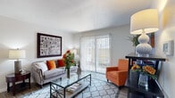 This single-floor residence offers a thoughtfully designed layout that balances comfort and functionality across its key living areas. The living room serves as the heart of the space, featuring wood-style flooring, a textured ceiling, and a large sliding glass door with vertical blinds that floods the room with natural light and opens to an outdoor patio. The open, welcoming atmosphere is well-suited for both relaxing and entertaining.

The galley-style kitchen is efficiently arranged with gray cabinetry, white countertops, and light wood-style flooring. It is equipped with stainless steel appliances including an electric range, microwave, and dishwasher, alongside a black refrigerator — providing ample functionality in a compact footprint.

Adjacent to the living area, a dedicated dining nook provides an intimate space for meals, finished with the same wood-style flooring that flows throughout the common areas.

The bedroom offers a cozy retreat with plush carpeting, a ceiling fan, and windows fitted with blinds for natural light and privacy. A connecting hallway leads to the full bathroom, which features a blue-gray vanity, quartz-style countertop, a large mirror, and medicine cabinet storage — combining practicality with a clean, modern aesthetic.