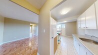 Located at 1275 Danforth Road in Toronto's Scarborough area, this three-bedroom, one-bathroom unit offers a practical and well-organized layout across a single floor. Classic parquet wood flooring runs throughout the living areas and all three bedrooms, lending warmth and character to the space.

The living room is bright and open, anchored by a large window that invites abundant natural light and provides views of the surrounding neighbourhood. A radiator beneath the window provides efficient heating. The room connects smoothly to the hallway, which leads to the three bedrooms and bathroom.

Each bedroom features the same warm parquet flooring and neutral wall tones. The primary bedroom is a comfortable size with a window overlooking greenery and the surrounding cityscape. The two additional bedrooms are similarly appointed, with windows offering views of the parking area and neighbouring buildings. One bedroom also includes access to a dedicated closet.

The bathroom is clean and functional, finished with light grey tile flooring and white fixtures, including a vanity with cabinet storage and a mirrored medicine cabinet above.

The unit's neutral colour palette and consistent flooring throughout create a cohesive and adaptable living environment. Natural light flows generously through multiple windows, enhancing the overall sense of space.