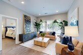 Located at 2550 Blackmon Dr in Decatur, GA, this well-appointed 2-bedroom, 4-bathroom residence offers a thoughtfully designed single-floor layout that maximizes both comfort and functionality. The open-concept kitchen and living area serves as the heart of the home, anchored by a striking waterfall-edge island with seating, two elegant pendant lights, and a bold two-tone cabinetry scheme pairing white uppers with deep navy lowers. Glass-front upper cabinets and stainless steel appliances complete the chef-inspired kitchen. Warm hardwood flooring flows throughout, unifying the space seamlessly. The living room is bathed in natural light from large windows with outdoor views, creating a bright and inviting atmosphere. Two generously sized bedrooms each feature large windows, neutral tones, and access to well-appointed closets. The bathrooms are finished with large-format marble-look tile, frameless glass shower enclosures, and mosaic tile flooring, conveying a spa-like aesthetic. A dedicated nook area off the kitchen provides additional functional space. With two walk-in closets and four full bathrooms across just two bedrooms, this residence delivers an exceptional level of privacy and convenience in a refined, modern package.