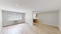 Located at 2086 Stanley St in New Britain, CT, this thoughtfully updated one-bedroom, one-bathroom unit offers a clean, modern aesthetic across a single floor. Light-toned luxury vinyl plank flooring runs throughout, creating a cohesive and bright atmosphere in every room.

The open living area is bathed in natural light from a large window fitted with blinds, and is equipped with a wall-mounted air conditioning unit and baseboard heating. Recessed lighting adds a polished finish to the space. The layout flows naturally into a well-appointed kitchen featuring warm wood lower cabinetry, crisp white upper cabinets, marble-look quartz countertops, a stainless steel sink with a modern gooseneck faucet, and a stainless steel range. A window above the counter brings in additional natural light.

The bedroom is a comfortable, well-proportioned room with its own window, recessed lighting, baseboard heating, and a closet with bifold doors offering built-in shelving and hanging space. The neutral gray walls carry throughout the unit, lending a calm, unified feel.

The bathroom is elegantly finished with large-format marble-look tile in the walk-in shower, mosaic tile flooring in the shower base, a white vanity with a clean countertop sink, and a mirrored medicine cabinet above.