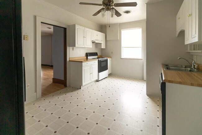 Kitchen. Electric stove, large side by side fridge, and in unit washer and dryer. Tons of cabinet - 700 1/2 Morgantown Ave