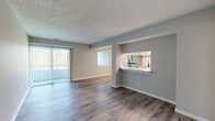 Located at 370 St Andrews Dr in Cincinnati, Ohio, this single-floor residence offers a thoughtfully updated interior with a clean, modern aesthetic throughout. The open-concept living and dining area is anchored by durable hardwood-style flooring and neutral gray-toned walls, creating a bright and versatile space. A sliding glass door with vertical blinds leads to an outdoor balcony, allowing natural light to flow freely into the living area.

The kitchen is accessible via a pass-through window with a marble-style countertop bar, making it ideal for casual dining or entertaining. Inside, the kitchen is well-appointed with white shaker-style cabinetry, a white subway tile backsplash, a stainless steel refrigerator, a dishwasher, and a single-basin sink — all set atop light-toned hardwood-style flooring that contrasts cleanly with the cabinetry.

The bedroom features plush carpeting, a textured ceiling, and a window with vertical blinds that brings in natural light while maintaining privacy. Throughout the unit, white baseboards and trim provide a crisp, finished look. The layout, as seen in the dollhouse view, is efficiently organized with well-defined spaces and ample closet storage, making this residence both functional and comfortable.