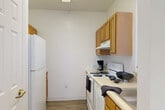 Located at 1645 Rio Hill Dr in Charlottesville, VA, this well-appointed one-bedroom, one-bathroom unit offers a clean, functional layout across a single floor. Throughout the space, warm wood-look flooring and crisp white walls create a bright, cohesive aesthetic.

The living room is a comfortable gathering area highlighted by a large window that frames views of surrounding greenery, allowing natural light to fill the room. The open feel of the space is enhanced by clean lines and neutral tones throughout.

The kitchen is equipped with warm-toned wood cabinetry, light countertops, and an electric range, providing all the essentials for daily cooking needs. The layout makes efficient use of the available space.

The bedroom is a well-sized private retreat, featuring wood-look flooring, a window with natural light, and ample wall space. The room offers a calm and restful atmosphere suited for comfortable living.

The bathroom includes a vanity with wood cabinetry, a toilet, and a full bathtub with a shower, complemented by built-in wire shelving for added storage convenience.

Overall, this unit presents a tidy, move-in-ready space with a straightforward and practical design, well-suited for individuals or couples seeking comfortable living in the Charlottesville area.