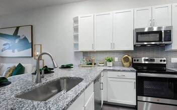 Kitchen with Granite Countertops, Stainless Steel Appliances, and Stylish Backsplash - The Harper