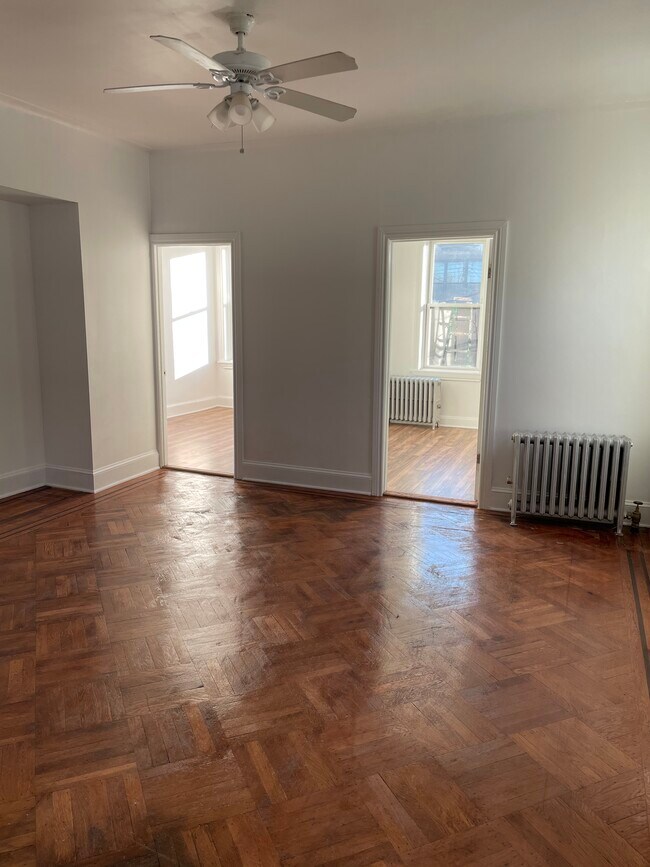 Original hardwood floors in living room. - 669 Essex St