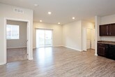 This single-floor residence offers a clean, modern design with a thoughtful layout spread across multiple rooms. The open-concept living and kitchen area serves as the heart of the home, featuring light wood-look luxury vinyl plank flooring, recessed lighting, and a sliding glass door that fills the space with natural light and provides outdoor access.

The kitchen is well-equipped with rich dark espresso cabinetry, granite-look countertops, and a full suite of black appliances including a range, microwave, dishwasher, and refrigerator. Generous upper and lower cabinet storage makes the kitchen highly functional.

The bedrooms are carpeted for comfort and feature neutral wall tones, windows with blinds for natural light and privacy, and closets — including a sliding-door closet in one room. A ceiling fan is present in the primary bedroom, adding to the comfort of the space.

The bathrooms are finished consistently with the kitchen, featuring matching dark cabinetry, granite-look countertops, and single-basin vanities with large mirrors. One bathroom includes a shower/tub combo, while another features a more open vanity layout. Light wood-look flooring runs throughout the bathrooms, complementing the overall design aesthetic. The space presents a cohesive, move-in-ready feel throughout.