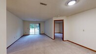 Located at 17285 W River Birch Dr in Brookfield, Wisconsin, this single-floor residence offers four bedrooms and two full bathrooms within a well-organized layout. The interior is finished with neutral-toned walls and plush wall-to-wall carpeting throughout the living and bedroom areas, creating a clean and consistent aesthetic. Warm wood-toned baseboards and door trim provide subtle contrast against the light walls.

The spacious primary bedroom is notably generous in size, offering ample room for comfortable furnishing. The additional three bedrooms are well-proportioned, each featuring carpeted floors and natural light from windows with outdoor views of the surrounding greenery. Several bedrooms include closet access via warm wood-panel doors.

The kitchen is equipped with oak cabinetry providing abundant storage, light-toned countertops, tile flooring, and white appliances including a refrigerator and range. The galley-style layout makes efficient use of the available space.

The two bathrooms mirror each other in style, featuring oak vanities with light countertops, tile flooring, and bright vanity lighting. One bathroom includes a full tub-shower combination with a mirrored medicine cabinet.

A connecting hallway with multiple doors leads seamlessly between the living areas, bedrooms, and service spaces, maintaining a logical and functional flow throughout the home.