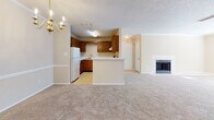 Located at 6012 Colony Park Dr in Birmingham, AL, this single-story unit offers a functional and comfortable layout throughout. The open-concept living and dining area is finished with neutral beige walls, plush wall-to-wall carpeting, and a textured ceiling. A wood-trimmed fireplace with a tiled surround serves as a focal point in the living space, which receives ample natural light through wide, blinds-fitted windows. A classic chandelier adds character to the dining area.

The kitchen is positioned adjacent to the living space and features warm-toned wood cabinetry, light countertops, a double-basin stainless steel sink, and a dishwasher. A peninsula provides a natural transition between the kitchen and living areas, enhancing the open flow of the floor plan.

The bedrooms are carpeted and finished in the same warm neutral palette, each with windows that allow natural light to filter in. The bathroom includes a wood-toned vanity with generous countertop space, a large mirror, and a tub-shower combination. Throughout the unit, consistent finishes and a cohesive color scheme create a calm, understated ambiance well-suited for everyday living.