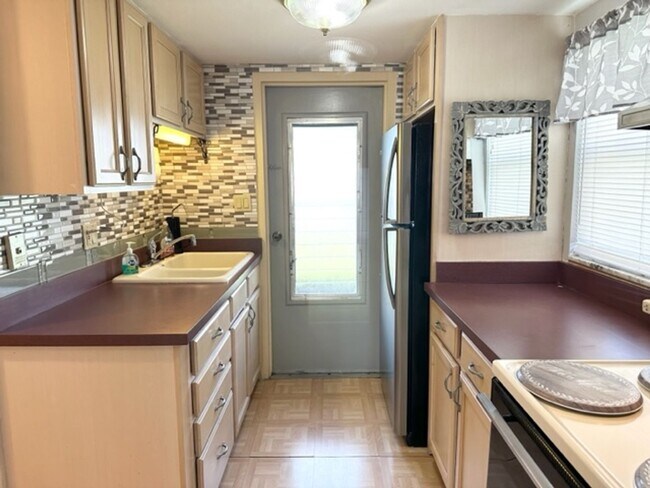 Building Photo - 55+ Community, FURNISHED 1BR/1BA CONDO IN ...