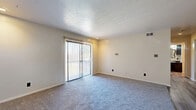 Located at 1 Camelot Dr in Parkersburg, West Virginia, this one-bedroom, one-bathroom residence offers a well-organized single-floor layout that makes efficient use of its space. The living room is a welcoming, carpeted area featuring a textured ceiling and a sliding glass door dressed with vertical blinds, allowing natural light to fill the room while providing access to the outdoors. The living space flows seamlessly into the dining area, which transitions to wood-look vinyl flooring, creating a clear and functional distinction between zones. The kitchen is equipped with deep-toned cabinetry featuring rich red-brown finishes, dark countertops, a full-size refrigerator, and a dishwasher, all set on durable wood-look flooring. The bedroom is a comfortably sized, carpeted room with a window that brings in natural light, and it benefits from two dedicated closets with bifold doors, offering generous storage. The bathroom features a herringbone-patterned tile floor, a tub-shower combination, and a vanity with dark cabinetry and a countertop sink. A hallway connects the main areas, with additional tile flooring providing a cohesive transition. The entrance area completes this practical and comfortable single-floor home.