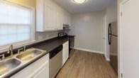 Located at 300 Pelham Rd in Greenville, SC, this two-floor residence offers a practical and well-organized layout with a variety of functional spaces throughout. The main level features a spacious living area with wood-style plank flooring, neutral-toned walls, a textured ceiling, and a front entry door flanked by a window that allows natural light to fill the room. A staircase connects the two floors seamlessly. The kitchen is equipped with white cabinetry, dark countertops, a stainless sink, a dishwasher, and an electric range, complemented by wood-style flooring and a window for added brightness. A bathroom on this level features a white vanity, framed mirror, and brushed nickel fixtures. The upper floor hosts multiple carpeted bedrooms, each fitted with ceiling fans and windows providing natural light. The primary bedroom includes dual closets offering generous storage. An additional lower-level bonus room features wood-style flooring and recessed lighting, providing flexible space for various uses. A second bathroom mirrors the clean, neutral aesthetic with a white vanity and coordinating fixtures. Throughout both floors, the consistent use of neutral tones, clean finishes, and practical design elements creates a cohesive and comfortable living environment.